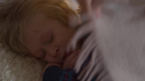 Closeup Happy Charming Brother Sleeping As Sister Covering Sibling with Blanket Kissing Cheek