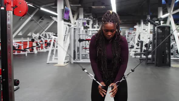 Sports Training an Africanamerican Woman Training Her Hands with Pulling the Holders Attached To the