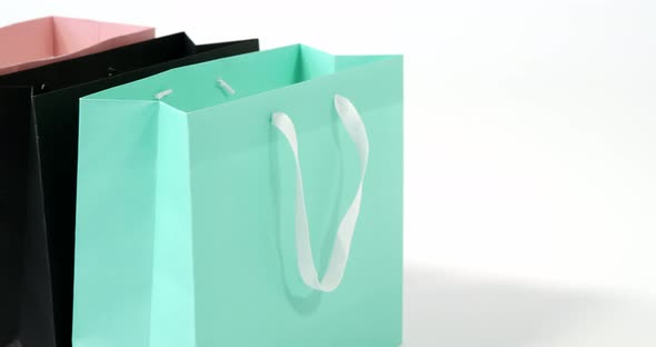 Multicolored shopping bags on white background