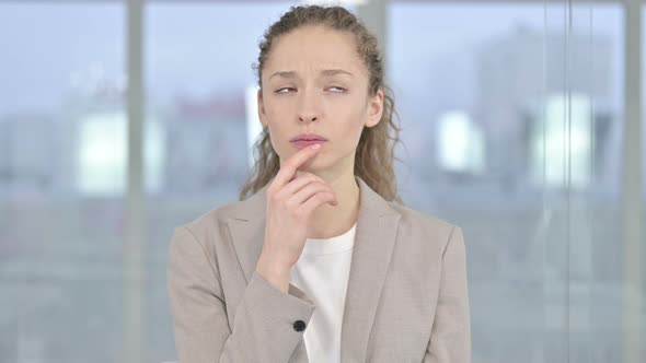 Portrait of Attractive Young Businesswoman Thinking About Something 