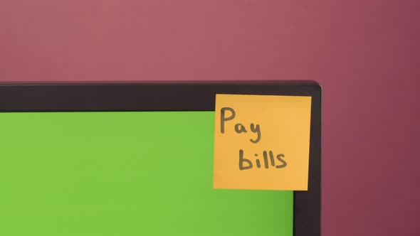 "Pay Bills" Paper Sticker Glued on Pc, Chroma Key. Red Background. Copy Space