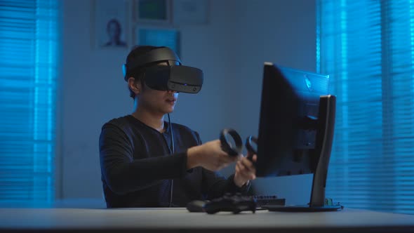 Asian young man playing video game in virtual reality headset