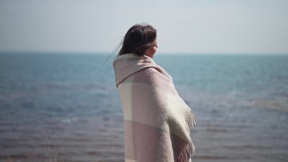 Side View Happy Woman Wrapped in Blanket Admiring River Standing on Shore Outdoors