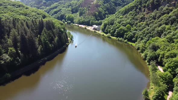Aerial flight showing saar river curve with riding luxury boat during beautiful day