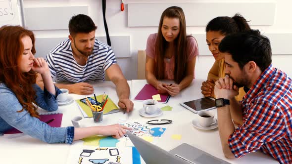 Graphic designers interacting with each other during meeting