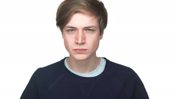 Portrait of Young Aggressive Teen Looking on Camera with Penetrating Gaze Squinting Being Angry Over