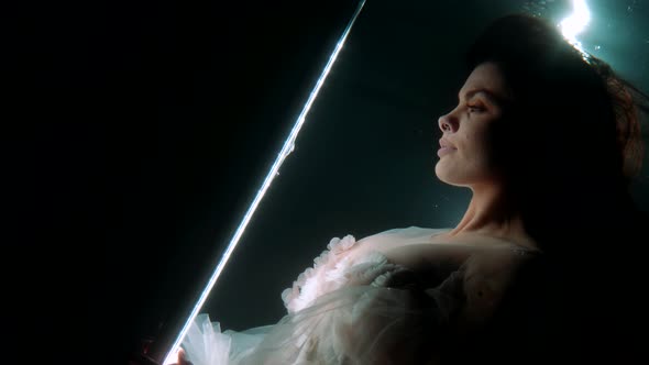 Fabulous Underwater Shot with Stunning Brunette Lady Drowning in Dark Depth of Sea or River