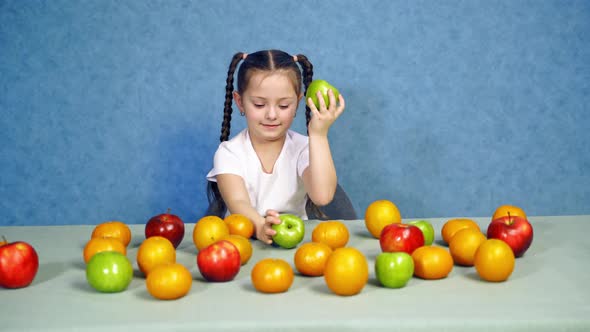 Portrait of a Cute Little Girl With Fruits Indoors