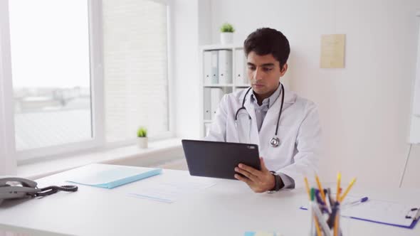 Doctor with Tablet Pc and Papers at Hospital 