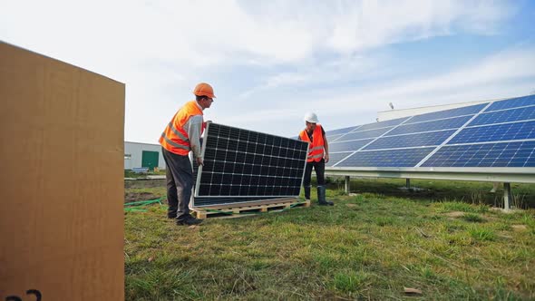 Workers Installing Photovoltaic Panels for Renewable Energy