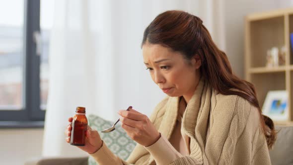 Sick Asian Woman Taking Medicine at Home