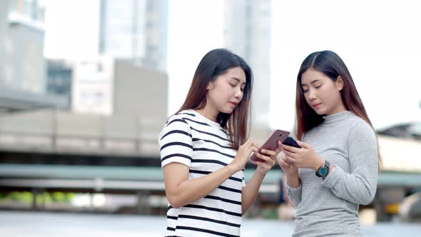 Two Teenager travellers checking location map on smartphone 