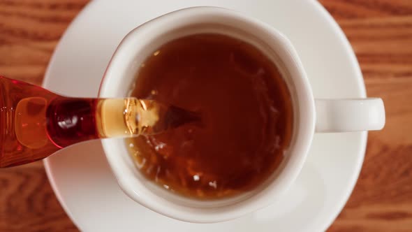 Pouring Black Tea Into Cup Top View