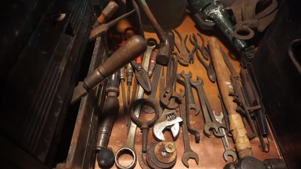 Tracking shot of tools on workbench.