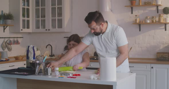 Father and Daughter Preparing Cakes Together