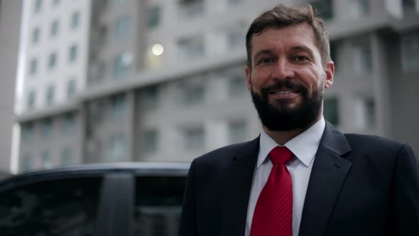 Portrait Business Man in an Expensive Suit and a Red Tie a Handsome Bearded Senior Businessman in