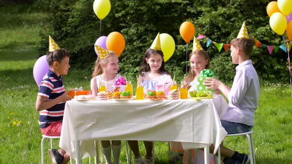 Kids Giving Presents To Birthday Girl at Party 10