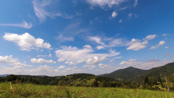 Time Lapse Beautiful Clouds Floating By the Sky Above Mountains in Sunny Day