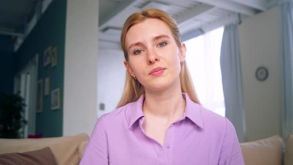 Young woman talking to camera making conference video call