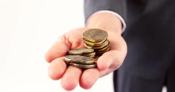 Mid-section of man holding coins