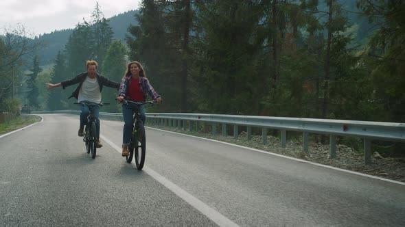 Lovers Cycling Mountain Bikes on Nature Road