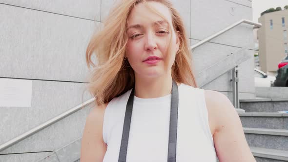 Slow motion headshot young caucasian woman posing outdoor looking camera