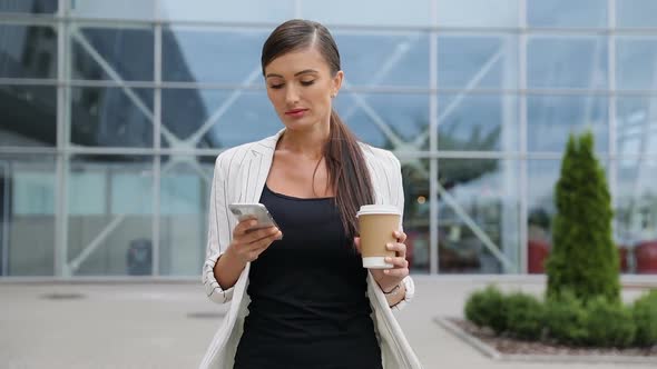Business Woman With Phone And Coffee Going To Work