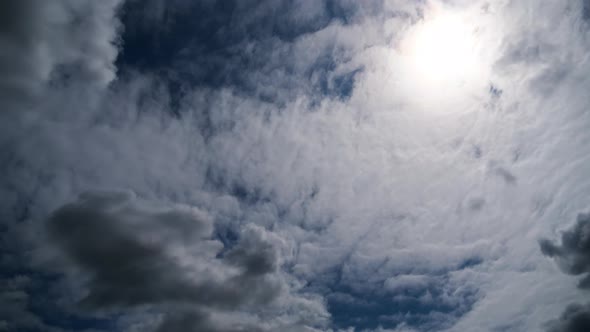 Clouds Move Smoothly in the Blue Sky on Background of Sun. Timelapse