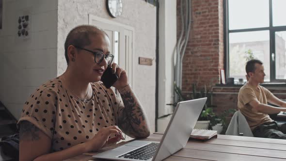 Woman Talking on Phone in Coworking