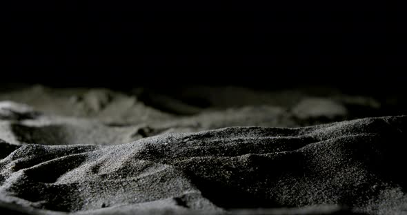 Hands Close-up That Touch and Sprinkle Sand on the Sandy Beach Late at Night.