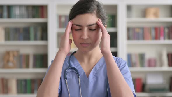 Portrait of Indian Female Doctor having Headache