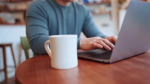 Young man working by laptop