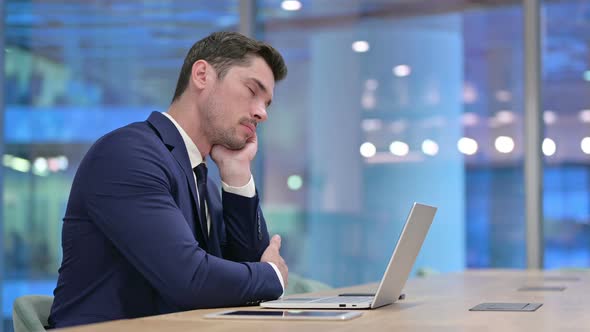 Tired Young Businessman Sleeping at Work