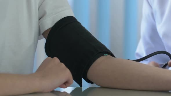 Doctor Measuring Boy Blood Pressure With Stethoscope, Draft Checkup Medical Care