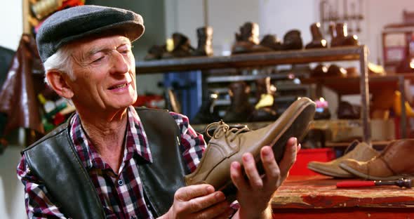 Shoemaker examining a shoe