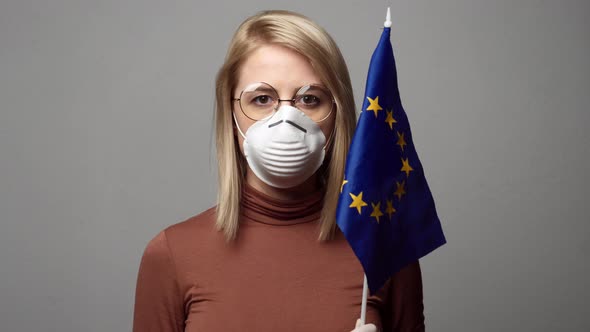 blonde lady in face mask with EU flag