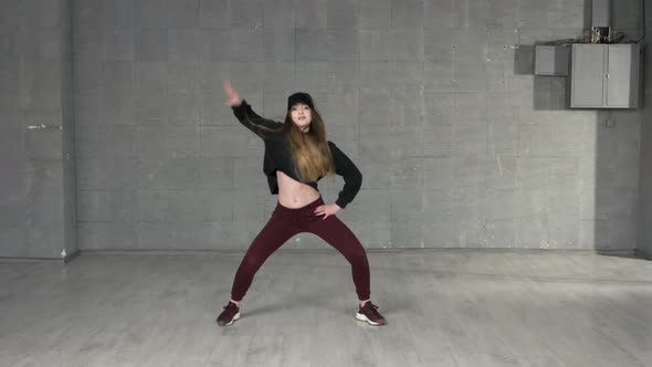 Young Energetic Girl Dancing Modern Dance in Studio