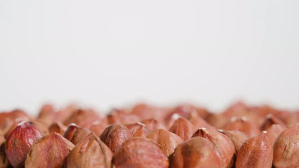 Red Hazelnuts Rotate on a White Background