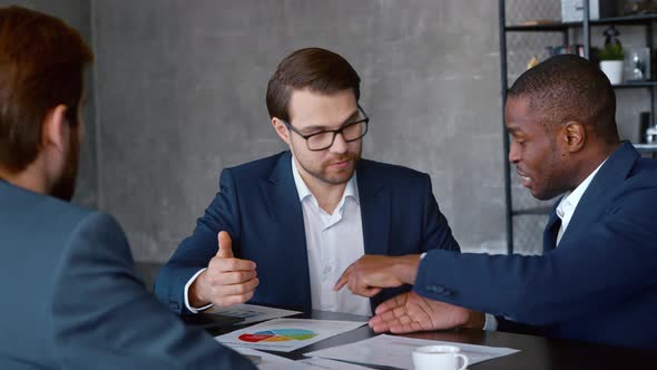 Young businessman with a team at a meeting in workplace