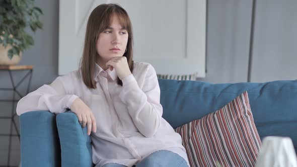 Penisve Casual Girl Thinking While Sitting on Couch
