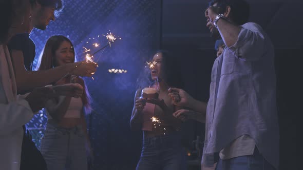 Friends Celebrating with Cake and Sparklers in Party