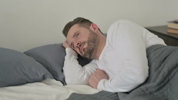 Man Awake in Bed Thinking