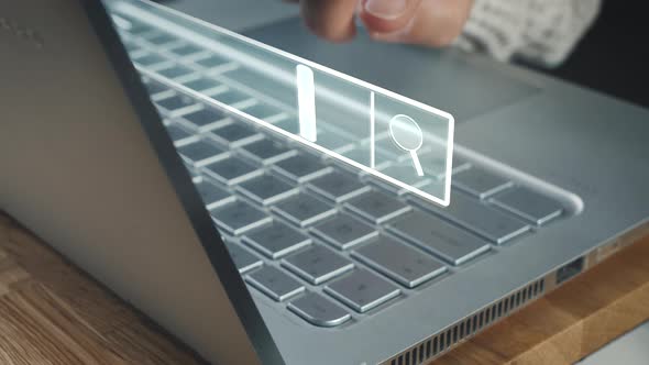 Female person searches for online shopping websites on her laptop using a digital input mask