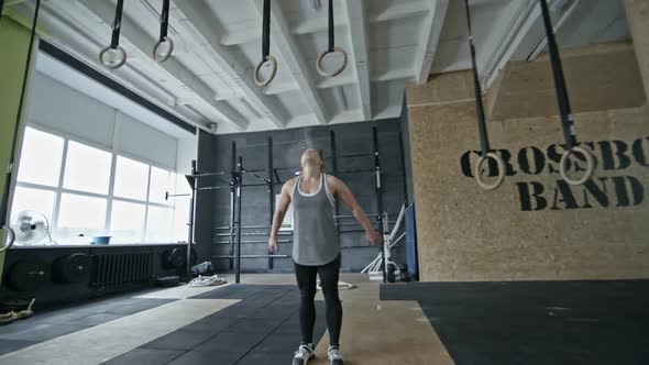 Sporty Woman Doing Pull-Ups on Rings