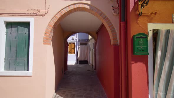 Short Arch Walkway Between Old Houses with Cobbled Road