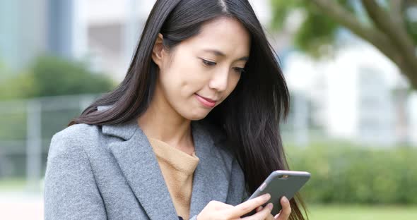 Woman use of smart phone in park