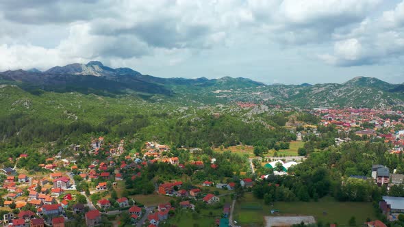 Aerial view of village houses with red roofs in Cetinje Montenegro Mountains