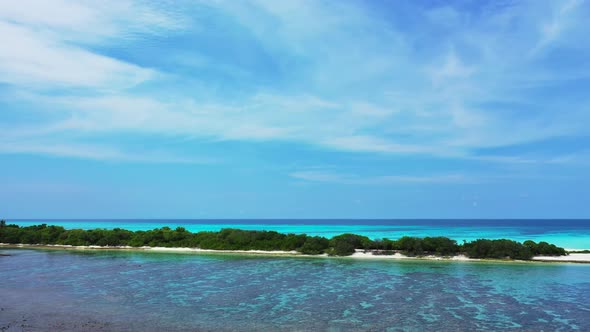 Daytime overhead copy space shot of a sunshine white sandy paradise beach and blue water background 