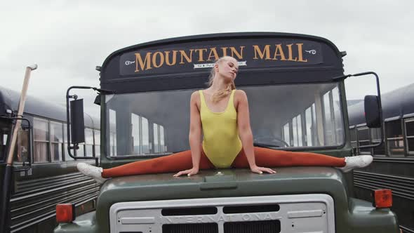 Flexible Dancer Doing Splits On Bus Hood