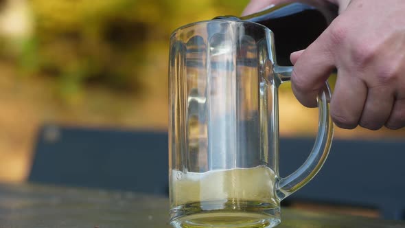 Delicious bottle of beer flows into a classic German beer glass